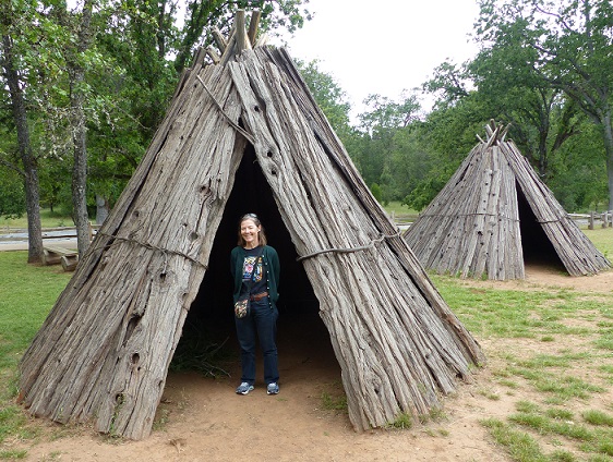 Alison in a Miwok house at Grinding Rock State Park